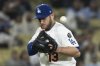 Los Angeles Dodgers third baseman Max Muncy bobbles the ball during the ninth inning of a baseball game against the Miami Marlins in Los Angeles, Tuesday, April 29, 2025. (AP Photo/Kyusung Gong)