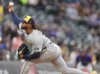 Milwaukee Brewers starting pitcher Freddy Peralta works against the Colorado Rockies in the first inning of a baseball game Tuesday, April 8, 2025, in Denver. (AP Photo/David Zalubowski)