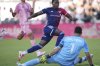 FC Dallas midfielder Anderson Julio (11) jumps over Inter Miami goalkeeper Drake Callender (1) as he follows his goal during the second half of an MLS soccer match, Sunday, April 27, 2025, in Fort Lauderdale, Fla. (AP Photo/Jim Rassol)