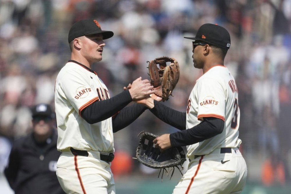 San Francisco Giants third baseman Matt Chapman, left, celebrates with first baseman LaMonte Wade Jr. after a baseball game against the Colorado Rockies in San Francisco, Saturday, May 3, 2025. (AP Photo/Jeff Chiu)