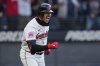 Cleveland Guardians' Nolan Jones celebrates as he runs to first base with a walk in the ninth inning of a baseball game against the Chicago White Sox, brining in the winning run, in Cleveland, Tuesday, April 8, 2025. (AP Photo/Sue Ogrocki)
