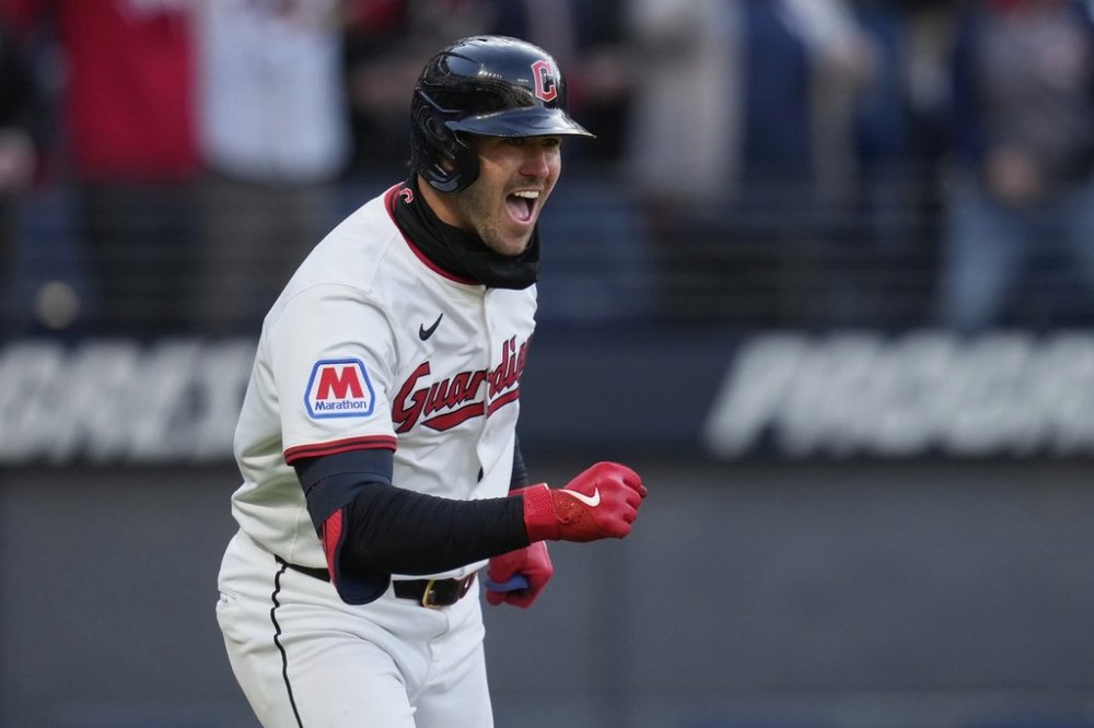 Cleveland Guardians' Nolan Jones celebrates as he runs to first base with a walk in the ninth inning of a baseball game against the Chicago White Sox, brining in the winning run, in Cleveland, Tuesday, April 8, 2025. (AP Photo/Sue Ogrocki)