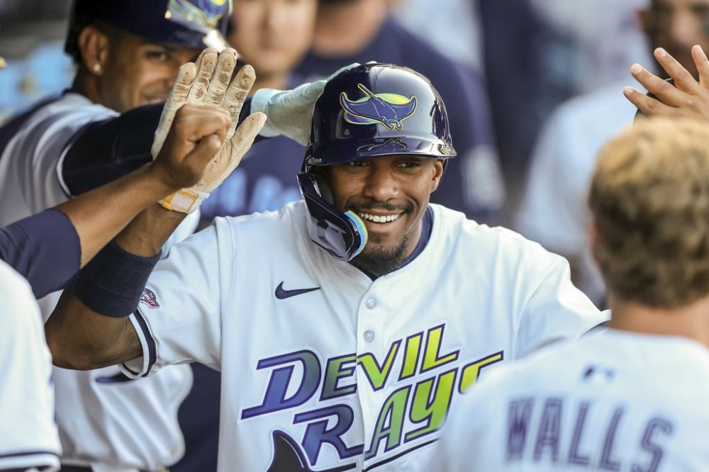 Tampa Bay Rays' Chandler Simpson is congratulated after scoring during the ninth inning of a baseball game against the New York Yankees, Saturday, April 19, 2025, in Tampa, Fla. (AP Photo/Mike Carlson)