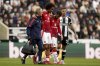 Manchester United's Joshua Zirkzee, second left, is helped from the pitch after picking up an injury during the English Premier League soccer match between Newcastle United and Manchester United in Newcastle upon Tyne, England, Sunday, April 13, 2025. (Owen Humphreys/PA via AP)
