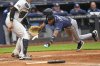 Tampa Bay Rays' Chandler Simpson, right, dives home on a single hit by Yandy Díaz during the fourth inning of a baseball game against the New York Yankees, Sunday, May 4, 2025, in New York. (AP Photo/Seth Wenig)