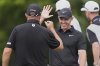 Rory McIlroy, of North Ireland, facing, reacts with teammate Shane Lowry, of Ireland, after Lowry's birdie putt on the 10th hole during the first round of the PGA Zurich Classic golf tournament at TPC Louisiana in Avondale, La., Thursday, April 24, 2025. (AP Photo/Gerald Herbert)