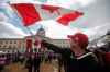 JOHN WOODS / FREE PRESS
Adam Hannah waves his flag as hundreds of people gather at the legislative grounds for the Rally For Canada, Sunday, April 6, 2025.