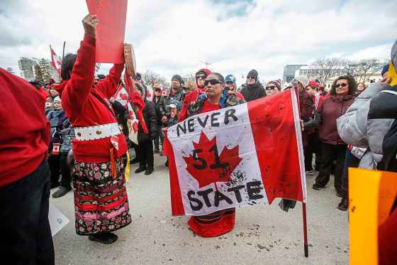 Protesters make their way to the stage as hundreds of people gather at the Manitoba Legislative Building grounds for the Rally For Canada on Sunday. (John Wodds / Free Press)