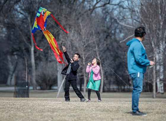 Mattias and his sister Evelyn launch their kite with their dad Juan at Assiniboine Park on Sunday. (John Woods / Free Press)