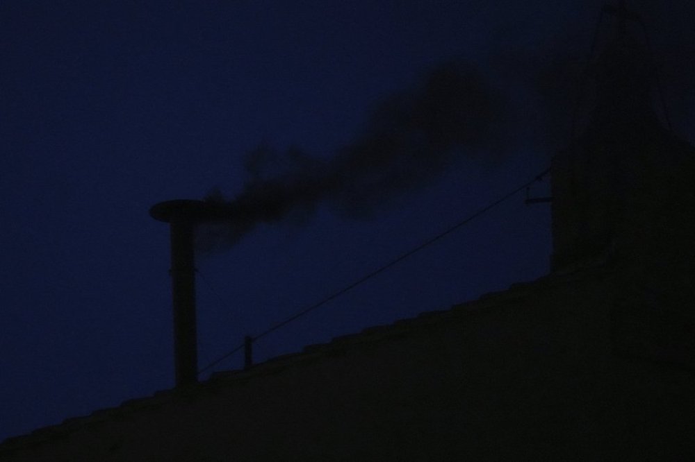 Black smoke billows from the chimney of the Sistine Chapel during the conclave to elect a new pope, at the Vatican, Wednesday, May 7, 2025. (AP Photo/Andrew Medichini)