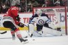 Winnipeg Jets goaltender Connor Hellebuyck (37) stops a shot from Chicago Blackhawks right wing Ilya Mikheyev (95) during the second period of an NHL hockey game Saturday, April 12, 2025, in Chicago. (AP Photo/Erin Hooley)