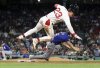 Boston Red Sox's Romy Gonzalez (23) is airborne as he collides with Texas Rangers first baseman Josh Smith in the sixth inning of a baseball game on Wednesday, May 7, 2025, in Boston. (AP Photo/Jim Davis)