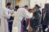 FILE - The Rev. Brian Strassburger, left, and the Rev. Flavio Bravo, right, bless migrants during Mass at the Casa del Migrant shelter in Reynosa, Mexico, on Dec. 15, 2022. (AP Photo/Giovanna Dell'Orto, File)