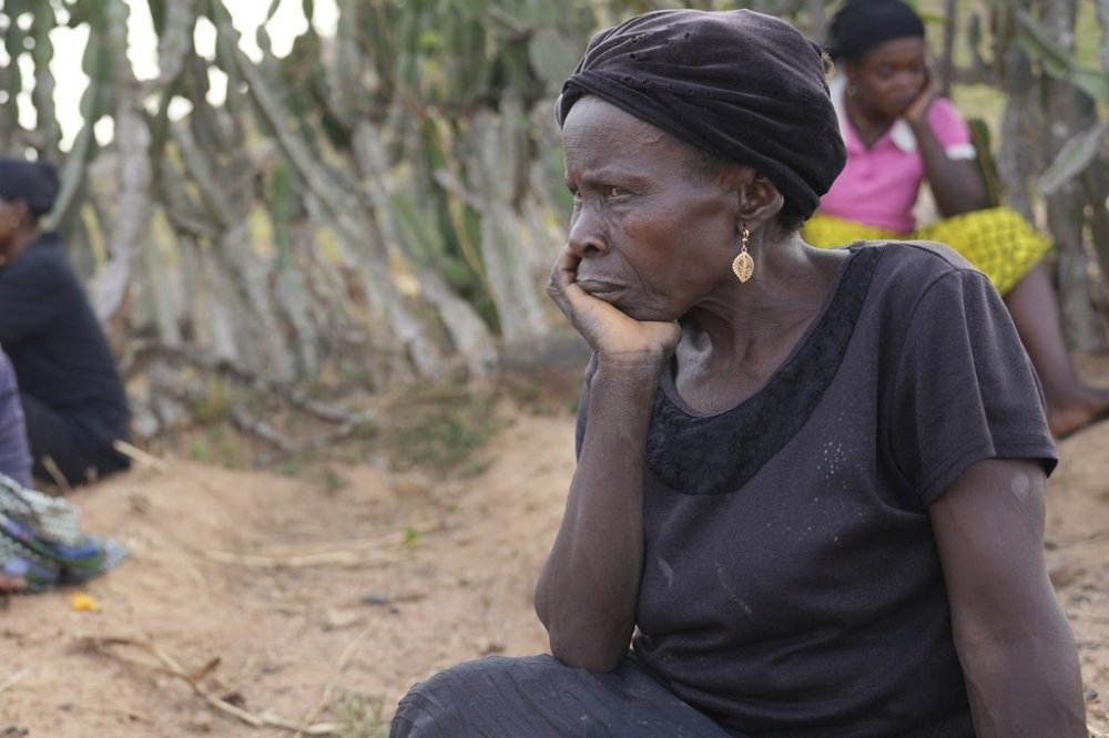 A woman mourns the death of a family member following an attack by gunmen in the Zike farming community in north-central Nigeria, Tuesday, April 15, 2025. (AP Photo/Samson Omale)