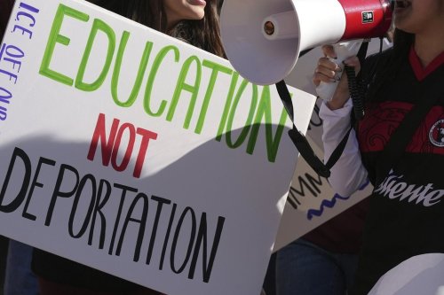 FILE - Students march at Arizona State University in protest of ASU's chapter of College Republicans United-led event encouraging students to report 