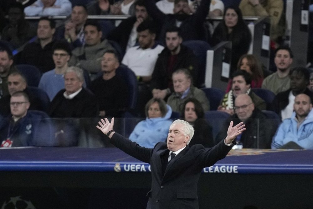 Real Madrid's head coach Carlo Ancelotti reacts during the Champions League quarterfinals second leg soccer match between Real Madrid and Arsenal at the Santiago Bernabeu stadium in Madrid, Wednesday, April 16, 2025. (AP Photo/Bernat Armangue)