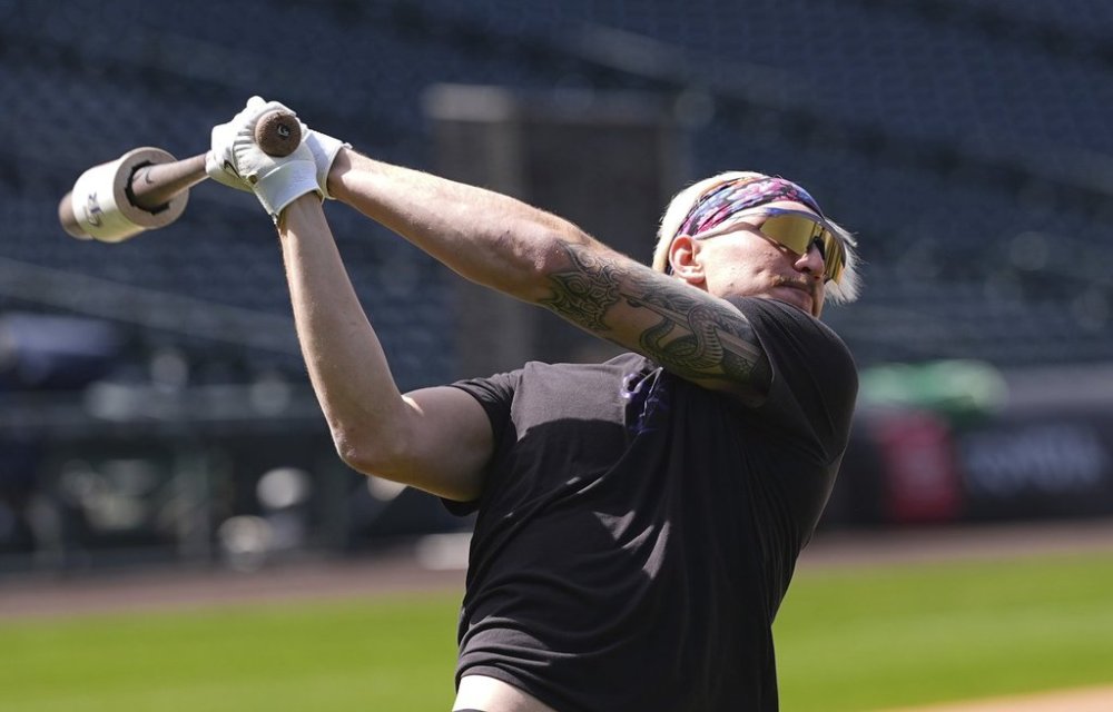 Colorado Rockies right field prospect Zac Veen, who was called up from Triple-A affiliate Albuquerque, warms up before appearing in his first Major League Baseball game against the Milwaukee Brewers, Tuesday, April 8, 2025, in Denver. (AP Photo/David Zalubowski)