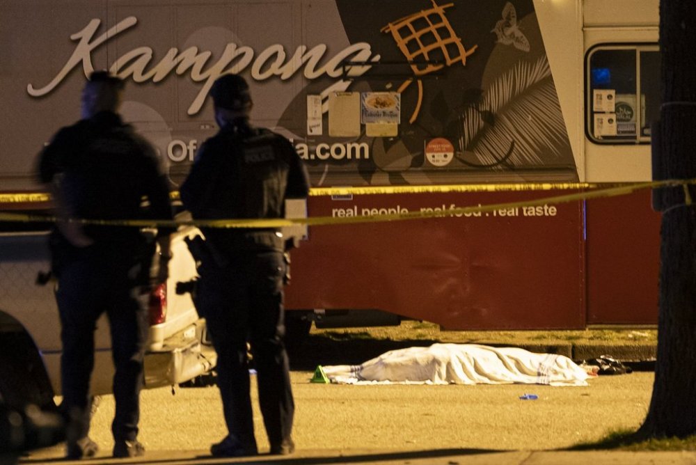 A victim lies near a food truck after a car drove into a crowd at the Lapu Lapu Festival in Vancouver on Saturday April 26, 2025. There has been a number of fatalities and numerous injuries. THE CANADIAN PRESS/Rich Lam