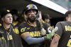 San Diego Padres' Fernando Tatis Jr. , center,is congratulated after scoring on a fielder's choice during the first inning of a baseball game against the Detroit Tigers, Monday, April 21, 2025, in Detroit. (AP Photo/Jose Juarez)