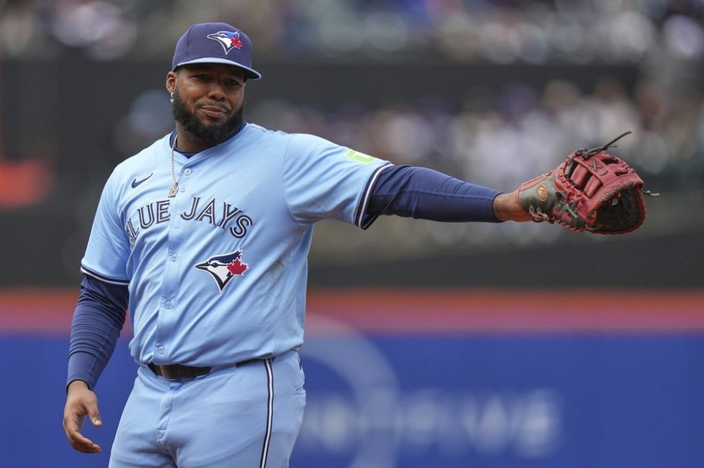 Toronto Blue Jays first baseman Vladimir Guerrero Jr. extends his arm during the first inning of a baseball game against the New York Mets on April 6, 2025, in New York. (AP Photo/Seth Wenig)