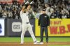 New York Yankees' Jasson Domínguez reacts after hitting a three-run double during the sixth inning of a baseball game Kansas City Royals Tuesday, April 15, 2025, in New York. All the players are wearing 42 in honor of Jackie Robinson Day. (AP Photo/Seth Wenig)