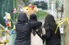 Members of the public gather at a memorial site for the victims of an incident where a car drove through a crowd killing multiple people in Vancouver, Monday April 28, 2025. THE CANADIAN PRESS/Rich Lam