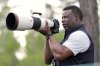 Former MLB great Ken Griffey Jr. takes photos on the 12th hole during the second round at the Masters golf tournament, Friday, April 11, 2025, in Augusta, Ga. (AP Photo/Ashley Landis)