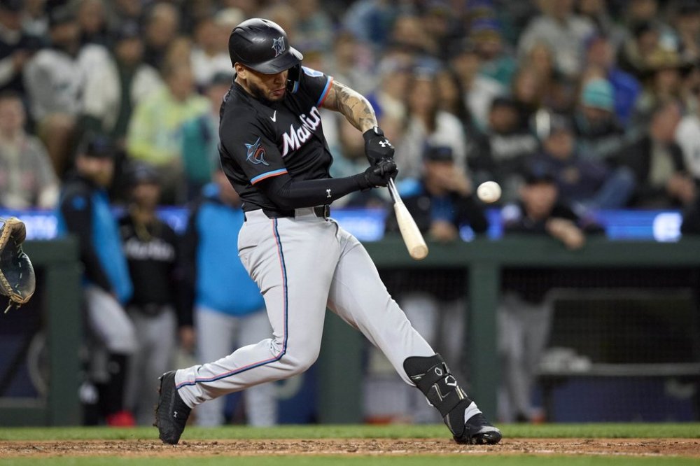 Miami Marlins' Agustín Ramírez hits a two-run home run on a pitch from Seattle Mariners pitcher Casey Lawrence during the eighth inning of of a baseball game, Friday, April 25, 2025, in Seattle. (AP Photo/John Froschauer)