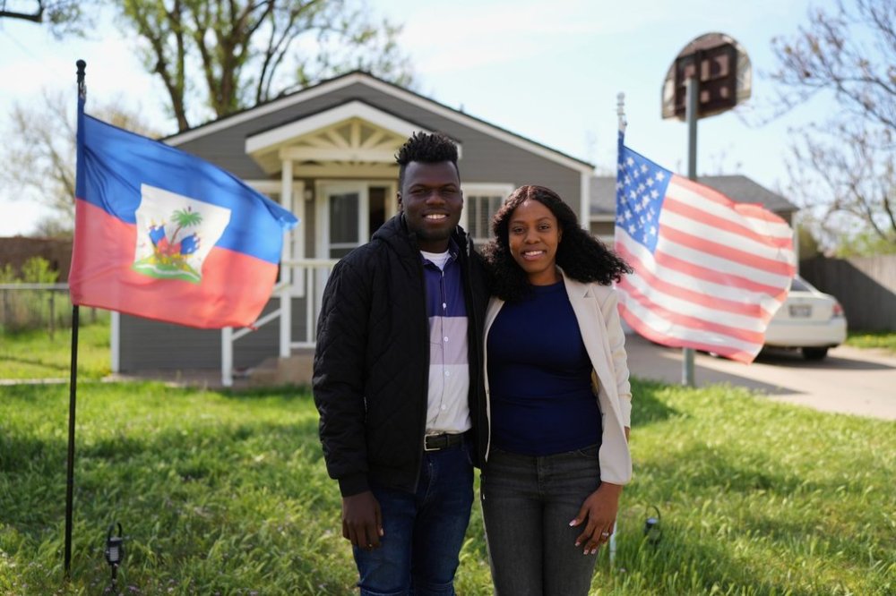 Haitian immigrants Kevenson Jean, a truck driver, and wife Sherlie Jean, a fast food worker, pose for a photo at their rental home, Monday, April 14, 2025, in Panhandle, Texas. (AP Photo/Eric Gay)