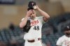 Minnesota Twins relief pitcher Justin Topa (48) adjusts his cap after committing a throwing error which resulted in a run scored during the sixth inning of a baseball game against the New York Mets, Monday, April 14, 2025, in Minneapolis. (AP Photo/Abbie Parr)