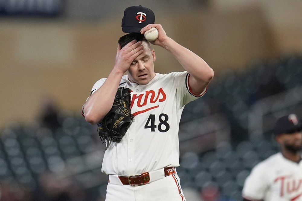 Minnesota Twins relief pitcher Justin Topa (48) adjusts his cap after committing a throwing error which resulted in a run scored during the sixth inning of a baseball game against the New York Mets, Monday, April 14, 2025, in Minneapolis. (AP Photo/Abbie Parr)