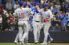 Chicago Cubs' Michael Busch (29) high-fives teammate Carson Kelly (15) after hitting a grand slam during the second inning of a baseball game against the Milwaukee Brewers, Friday, May 2, 2025, in Milwaukee. (AP Photo/Kayla Wolf)