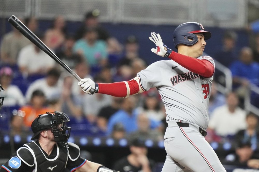 Washington Nationals' Nathaniel Lowe follows through on a double to score three runs during the eighth inning of a baseball game against the Miami Marlins, Friday, April 11, 2025, in Miami. (AP Photo/Lynne Sladky)