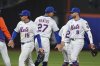 New York Mets' Tyrone Taylor (15) celebrates with teammates Mark Vientos (27), Brandon Nimmo (9) and Luisangel Acuña (2) after a baseball game against the St. Louis Cardinals Thursday, April 17, 2025, in New York. (AP Photo/Frank Franklin II)