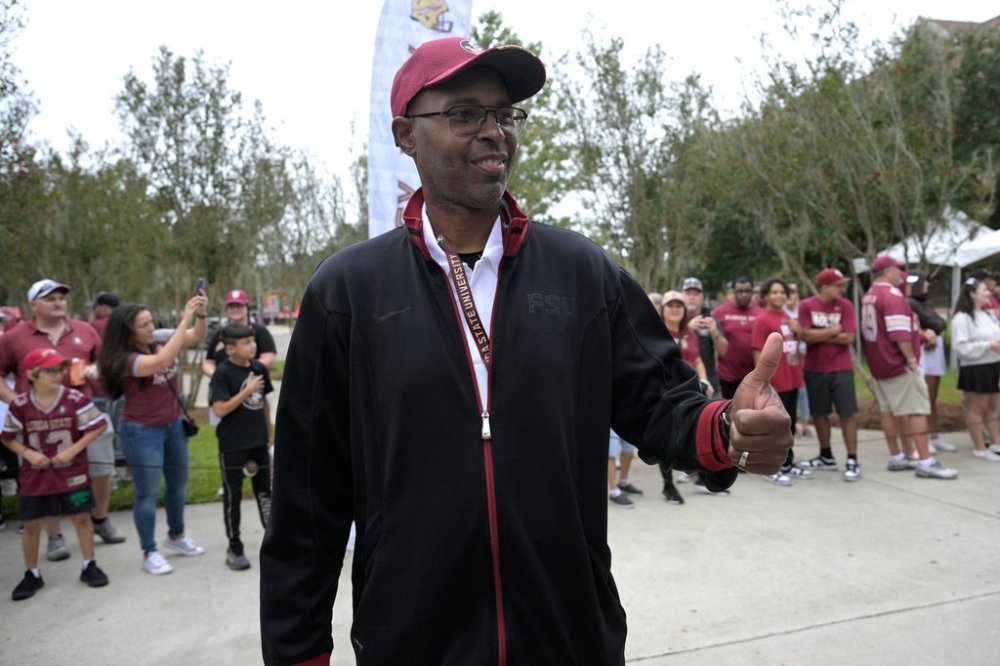 FILE - Former Florida State quarterback Charlie Ward interacts with fans as members of the 1993 National Championship team walk with current players to the stadium before an NCAA college football game against Syracuse, Saturday, Oct. 14, 2023, in Tallahassee, Fla. (AP Photo/Phelan M. Ebenhack,File)