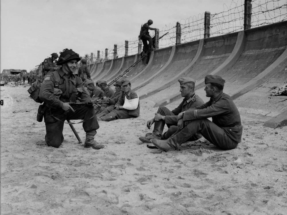NATIONAL ARCHIVES OF CANADA, FRANK L. DUBERVILL, PA-133754
Canadian troops watch over German prisoners at Juno Beach on D-Day.