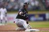 Chicago White Sox's Andrew Benintendi slides safely into third base against the Detroit Tigers in the first inning during a baseball game, Sunday, April 6, 2025, in Detroit. (AP Photo/Paul Sancya)