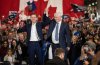 Former prime minister Stephen Harper, right, and Conservative Party Leader Pierre Poilievre raise hands at a rally during a campaign stop in Edmonton on Monday, April 7, 2025. THE CANADIAN PRESS/Jason Franson