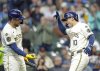 Milwaukee Brewers' Sal Frelick (10) reacts with Rhys Hoskins after Felick's home run against the Detroit Tigers during the sixth inning of a baseball game, Wednesday, April 16, 2025, in Milwaukee. (AP Photo/Jeffrey Phelps)