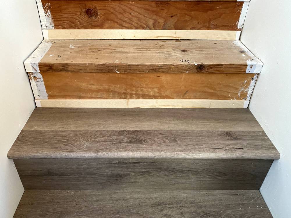 MARC LABOSSIERE / FREE PRESS
Shims are placed at the bottom of every rise to meet the protrusion of the existing lumber nosing, creating a plumb and level surface for the vinyl rise.