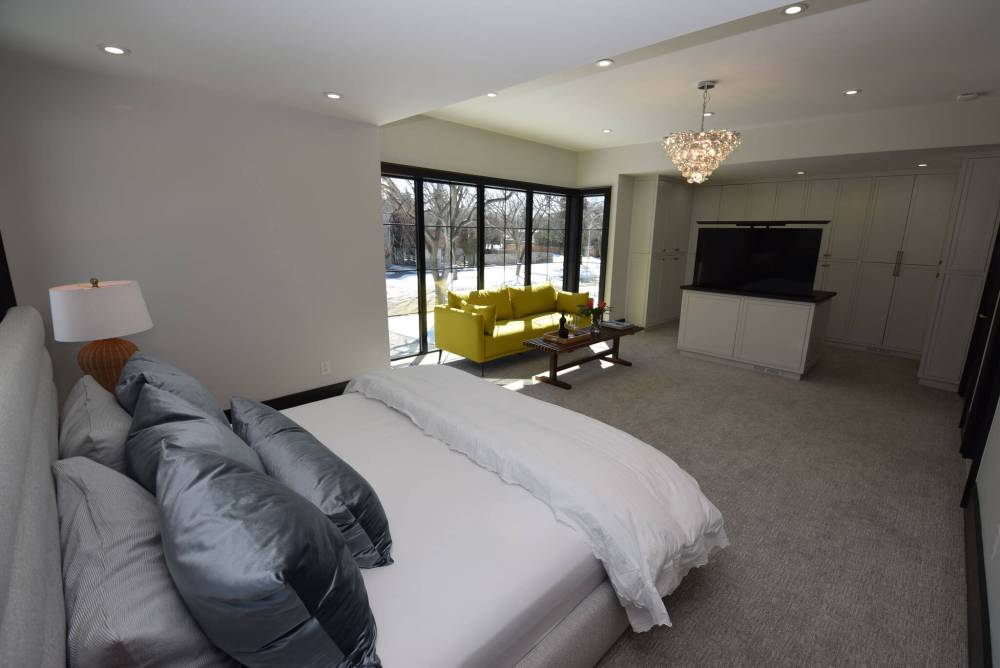 TODD LEWYS / FREE PRESS
A spacious, light-filled retreat, the private primary bedroom includes with a dressing area with a nifty island housing a retractable big-screen TV.