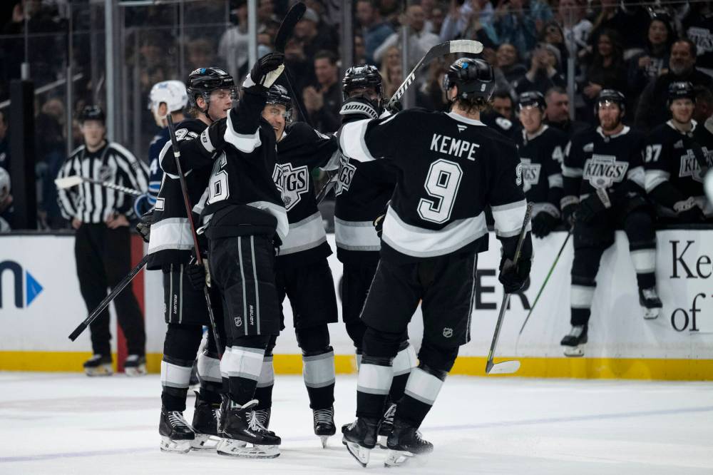 Los Angeles Kings players celebrate a goal by left wing Andrei Kuzmenko during the second period. (Kyusung Gong / The Associated Press)
