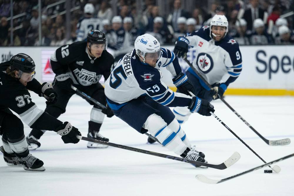 Kyusung Gong / THE ASSOCIATED PRESS
Winnipeg Jets’ Mark Scheifele (centre right) controls the puck as the Los Angeles Kings jockey for positioning during the third period on Tuesday in Los Angeles.