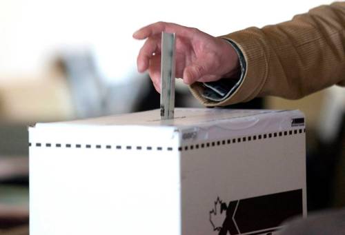 CHRIS YOUN / THE CANADIAN PRESS FILES
                                A man casts his vote for the federal election.