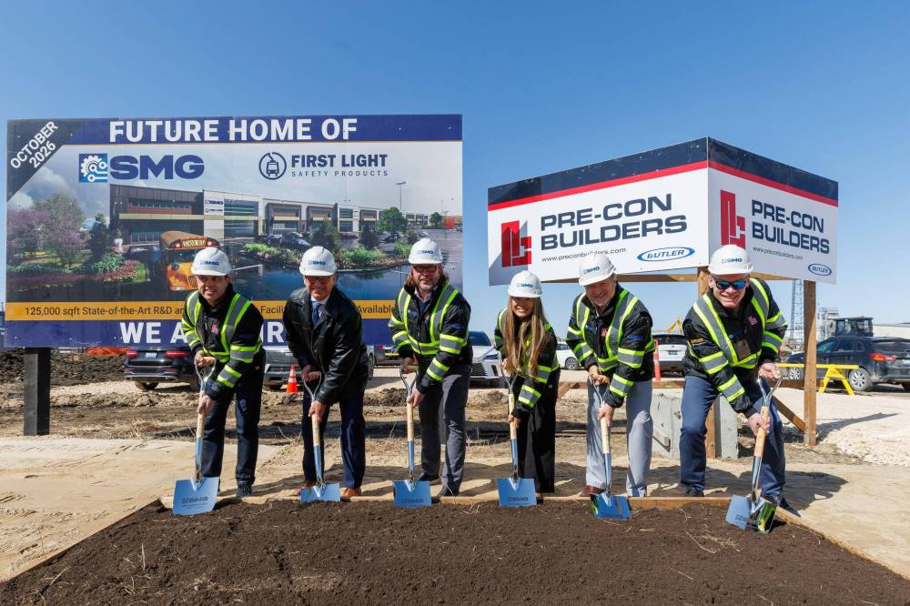 Daniel Simon, project manager with Pre-Con Builders (from left), Mayor Scott Gillingham; Kevin Smith, president/CEO of SMG; Cam Quan-Smith, V-P SMG; Scott Bearss and Gordon MacPherson, partners with Weathervane Realtors Group take part in a ground-breaking ceremony Monday in Winnipeg for a new manufacturing facility at 1455 Clarence Ave. (Mike Deal / Free Press)