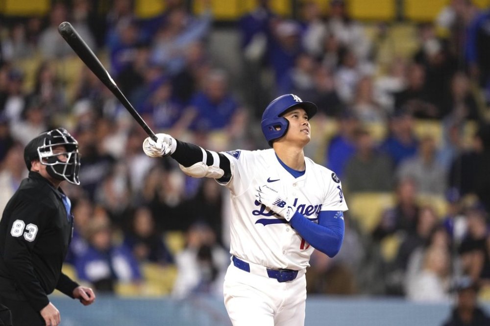 Los Angeles Dodgers' Shohei Ohtani watches his ball go out for a solo home run during the first inning of a baseball game against the Colorado Rockies Wednesday, April 16, 2025, in Los Angeles. (AP Photo/Mark J. Terrill)