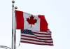 joe raedle / getty images FILE
                                A Canadian flag flies next to the American one at the Lewiston-Queenston border crossing bridge connecting Ontario and New York.
                                A Canadian flag flies next to the American one at the Lewiston-Queenston border crossing bridge on Feb. 4, 2025, in Niagara Falls, Canada. (Joe Raedle/Getty Images/TNS)