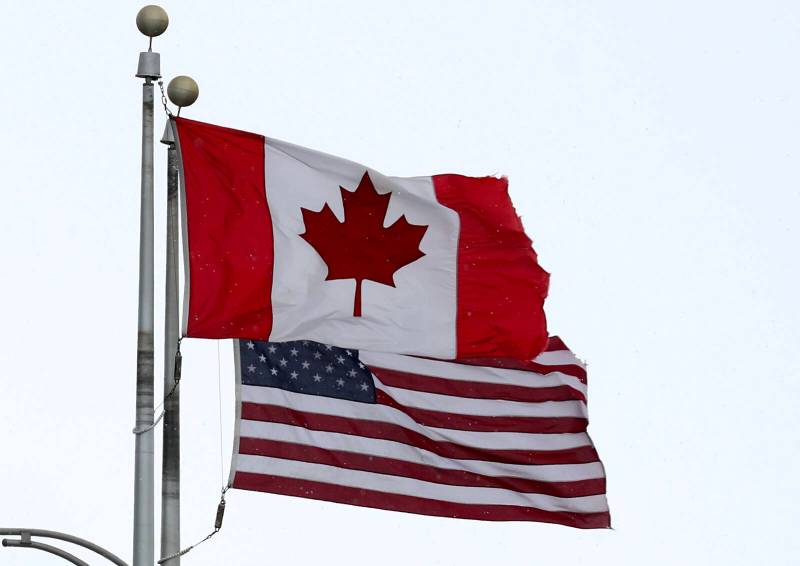 joe raedle / getty images FILE
                                A Canadian flag flies next to the American one at the Lewiston-Queenston border crossing bridge connecting Ontario and New York.
                                A Canadian flag flies next to the American one at the Lewiston-Queenston border crossing bridge on Feb. 4, 2025, in Niagara Falls, Canada. (Joe Raedle/Getty Images/TNS)