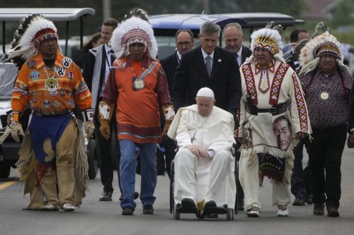 FILE - Pope Francis leaves with Indigenous peoples after praying in a cemetery at the former residential school in Maskwacis, near Edmonton, Canada, July 25, 2022. (AP Photo/Gregorio Borgia, File)