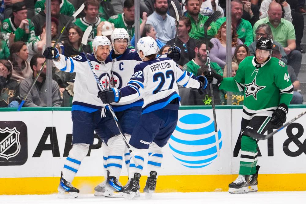 Julio Cortez / The Associated Press
Winnipeg Jets right winger Nino Niederreiter, left, celebrates his first period goal with teammates Adam Lowry, centre, and Mason Appleton Thursday, in Dallas.